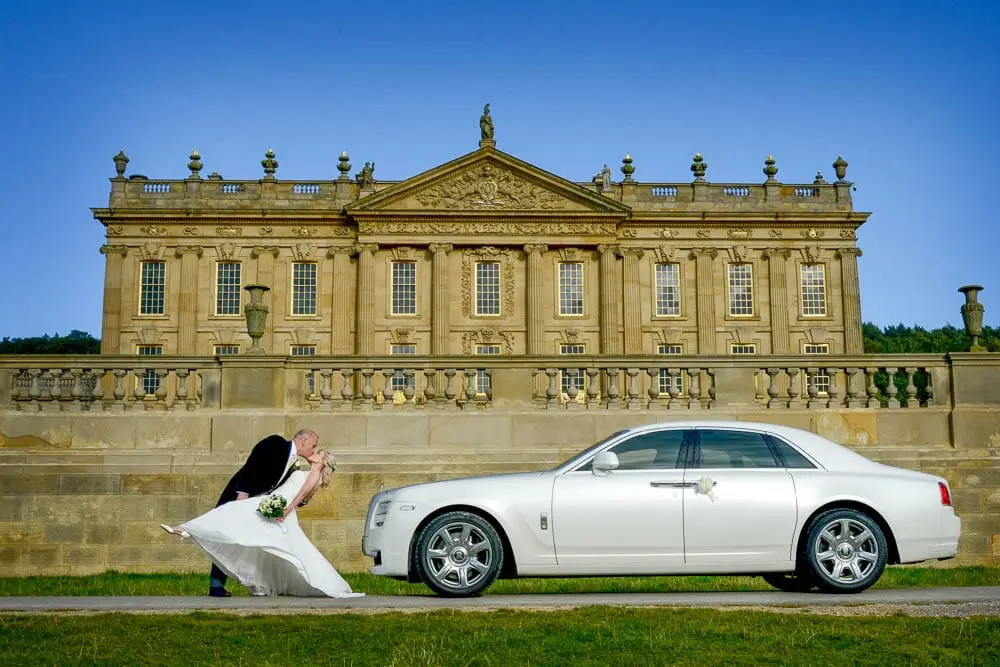 Wedding Photograph taken in a Derbyshire wedding venue in front of a white Rolls-Royce